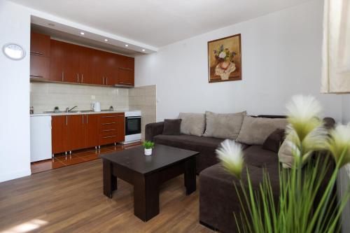 a living room with a couch and a table at Airport Stay Apartments in Surčin