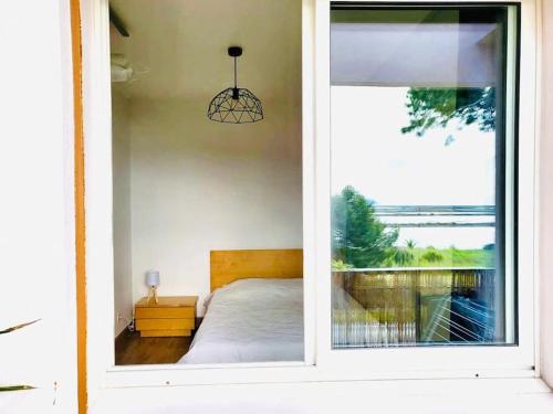 - une chambre avec un lit à travers une fenêtre dans l'établissement T2 apartment , beautiful view in Hyères near beach, à Hyères