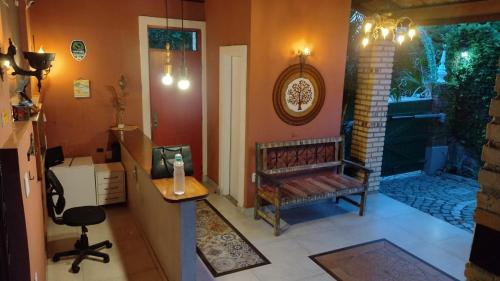 a living room with a bench and a table at Pousada Saruê Praia de Ponta Negra Natal RN in Natal