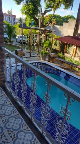 a small swimming pool with a metal railing at Pousada Saruê Praia de Ponta Negra Natal RN in Natal