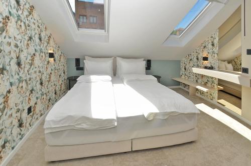 a large white bed in a room with a window at Ferhadija 31 Old town Sarajevo in Sarajevo