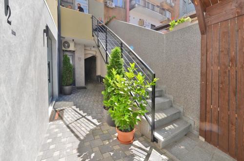a stairway with plants in pots next to a building at Ferhadija 31 Old town Sarajevo in Sarajevo