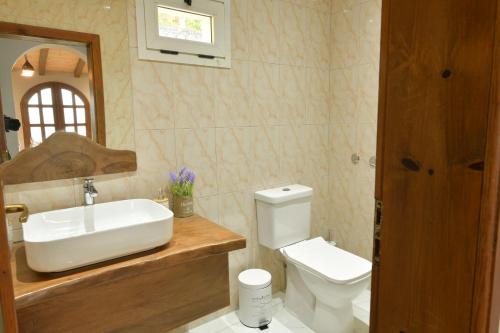 a bathroom with a sink and a toilet at White Pearl Villa in Široka