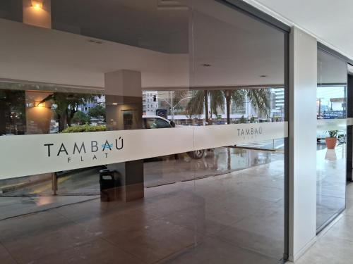a sign on the side of a glass building at hotel tambau flat particular 605 in João Pessoa