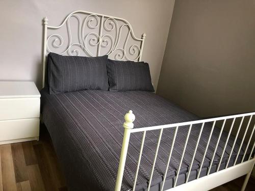 a bedroom with a bed with a white crib at Cliftonville Apartments in Belfast
