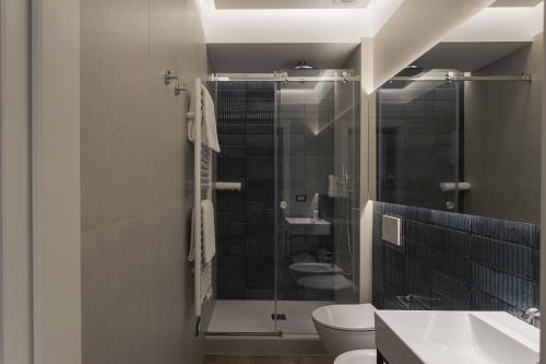 a bathroom with a shower and a toilet and a sink at Dimora Don Minzoni in Matera
