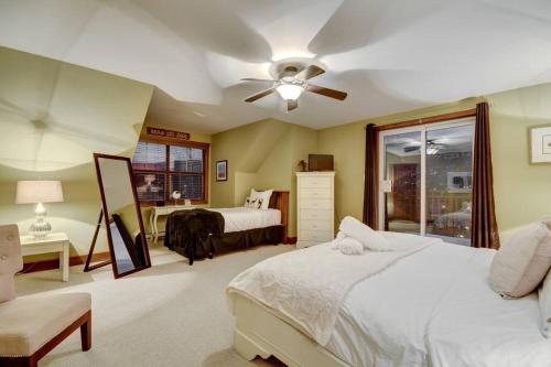 a bedroom with two beds and a ceiling fan at Les Eaux Tremblant Classic Chalet Pool & Jacuzzi in Mont-Tremblant