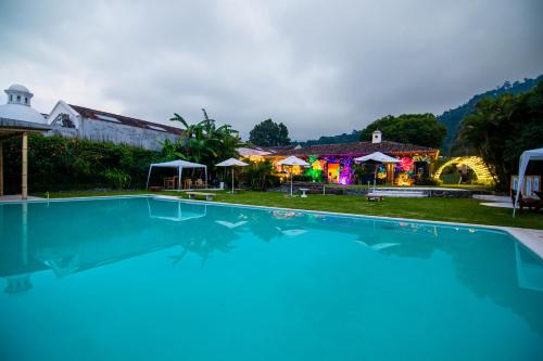 a large swimming pool in front of a house at Yes Please! Hostel in Antigua Guatemala