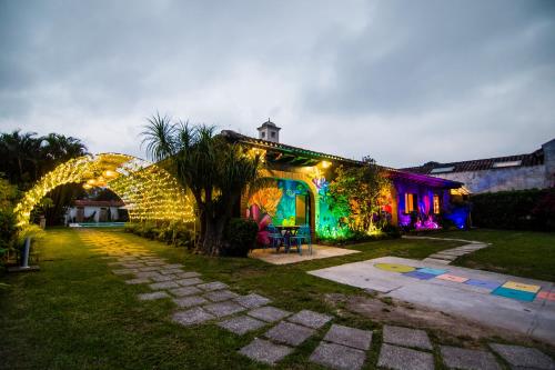 a house decorated with christmas lights in a yard at Yes Please! Hostel in Antigua Guatemala