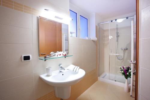 a bathroom with a sink and a shower at Residenza Romina sleeps 8 with pool- by Italian Apartments in Rezzonico