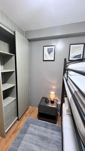 a bedroom with a bed and a desk in a room at Urban Charms Seawind Condo, 5 mins to Davao Int'l Airport and Wharf to Samal Beach in Davao City