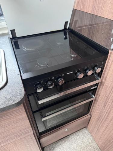 an oven in a kitchen with a glass door at Tayys Inn Luxury Camp in Birmingham