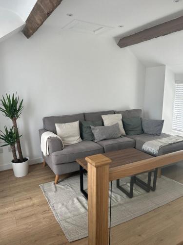 a living room with a couch and a table at Bay View House in Bangor