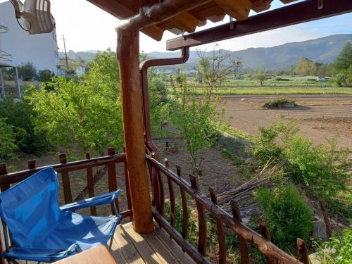 a blue chair on a porch with a view of a field at 1 bed - Sleeps 4 - Pets - Balcony - Mtn View in Coja
