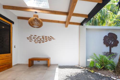 a porch with a wooden door and a wooden ceiling at El Remanso Rainforest Lodge in Puerto Jiménez