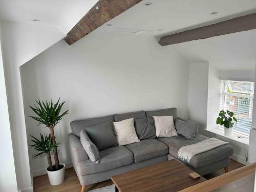 a living room with a couch and a table at Bay View House in Bangor