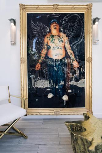 a painting of a man with tattoos on his torso in a room at Stanton House El Paso in El Paso