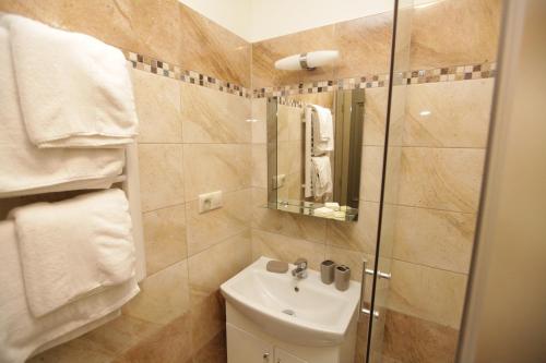 a bathroom with a sink and a shower at Kalvín Restaurant & Pension in Rastislavice