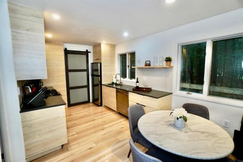 a kitchen and dining room with a table in a room at Poconos Oasis with Game Room in Pocono Summit