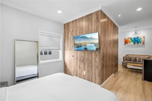 a bedroom with a white bed and a couch at 1628 West Oceanfront Oasis 9 in Newport Beach