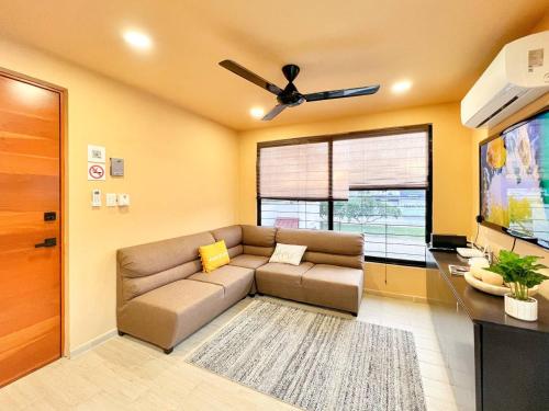 a living room with a couch and a flat screen tv at Depa Palenque 2 Cancun in Cancún