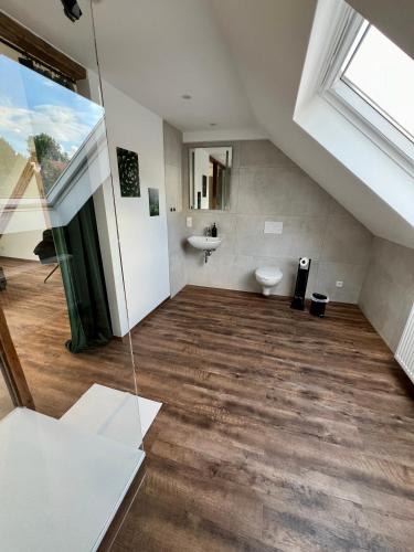 an attic bathroom with a toilet and a sink at Altes Eichamt Schweinfurt in Schweinfurt