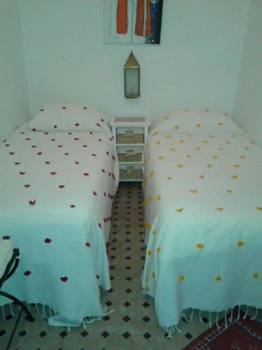 two twin beds in a bedroom with at Maison traditionnelle dans la casbah de Tanger in Tangier