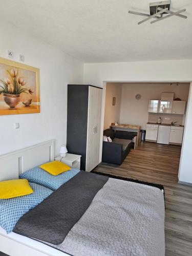a bedroom with a bed and a living room at Villa Bravo in Podstrana