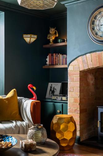 a living room with a couch and a fireplace at Chipping Campden Shabby Chic on Famous High Street in Chipping Campden