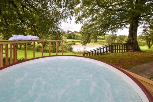 a large pool of water next to a fence at Ta Mill Cottages & Lodges - Brookview Lodge 3 in Launceston
