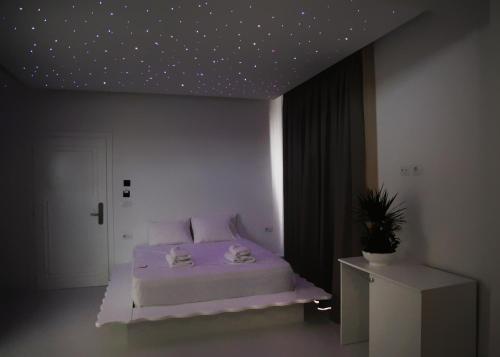 a bedroom with a bed with a star ceiling at Foga Hebrus in Ksamil