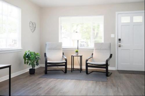 two chairs and a table in a living room at Spacious 4BR Home with 2 Baths & Fun Game Room in Birmingham