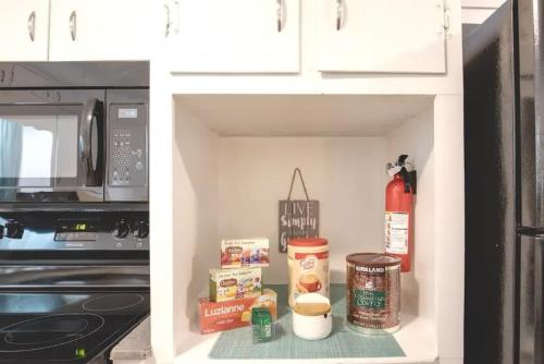 a kitchen cabinet with food items in it at Spacious 4BR Home with 2 Baths & Fun Game Room in Birmingham