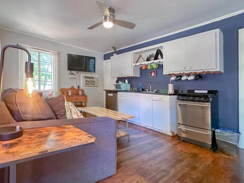 a kitchen and living room with a couch and a table at The Wanderoo Lodge in Eureka Springs