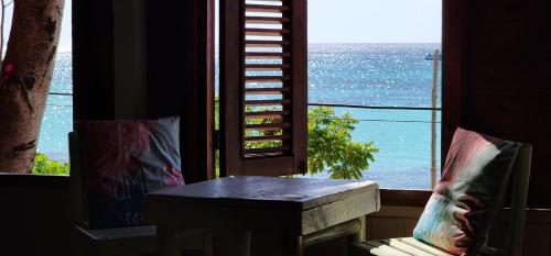 a room with a table and a view of the ocean at Tropic ecolodge in Punta Rucia