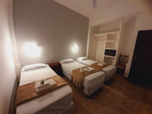 Postel nebo postele na pokoji v ubytování Hotel Emmanuel