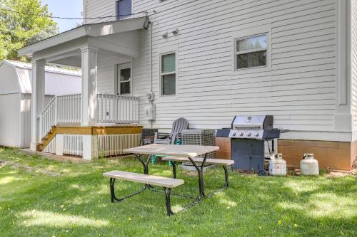 a picnic table and two chairs in the grass in front of a house at Home Near Downtown and Spearfish Canyon! in Spearfish