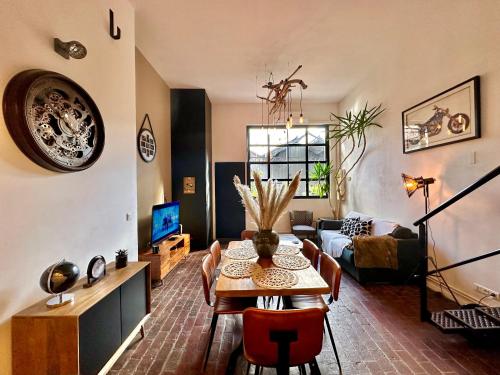 a living room with a table and a couch at Le Loft Rouen Centre in Rouen