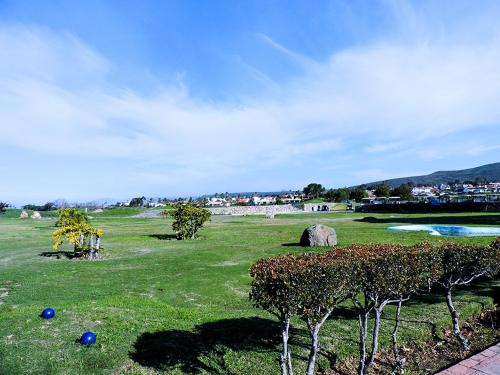 a field with some blue balls on the grass at Hacienda Bajamar in Sonorabampo