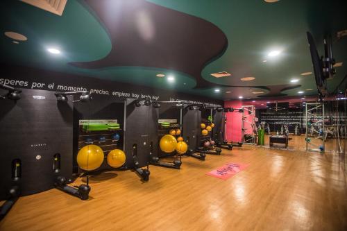 a gym with a bunch of equipment on a wooden floor at Azul Ixtapa Grand All Inclusive Suites - Spa & Convention Center in Ixtapa