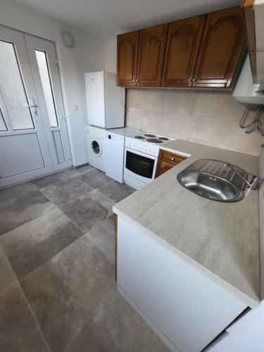 a kitchen with a sink and a stove at Sunset Pool Retreat in Zagrađe