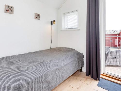 a bedroom with a bed and a window at 6 person holiday home in Hadsund-By Traum in Hadsund