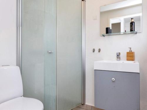 a bathroom with a toilet and a sink and a mirror at 6 person holiday home in Hadsund-By Traum in Hadsund