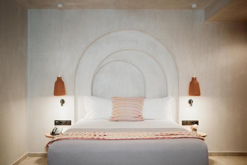 a bedroom with a bed with an arch above it at Kalani Residence in Keramotí