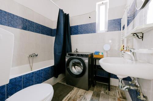 a bathroom with a washing machine and a sink at Stadium Apt in Kos