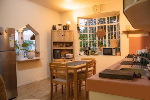 a kitchen with a table and chairs in a kitchen at Apartment with private rooftop 450 m from the beach in Flic-en-Flac