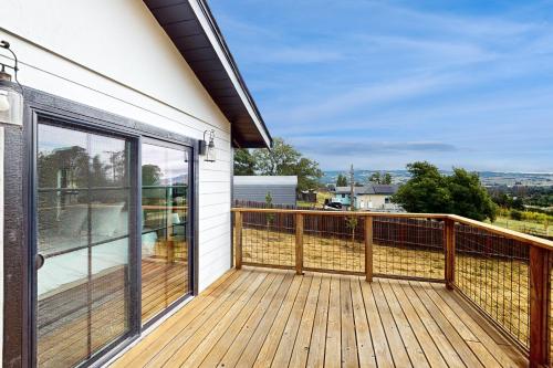 a deck with glass doors on a house at Penngrove Farmhouse Retreat in Penngrove