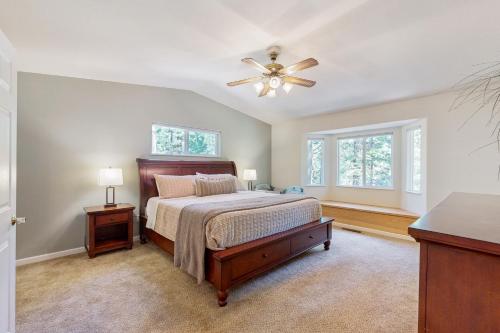 a bedroom with a bed and a ceiling fan at Fire Pit, Near Lake: 'Evergreen Escape' in Arnold in Arnold