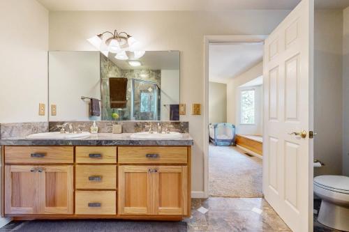 a bathroom with two sinks and a mirror at Fire Pit, Near Lake: 'Evergreen Escape' in Arnold in Arnold