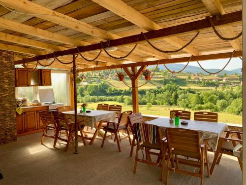 a dining room with tables and chairs with a view at CAMP Odmaraliste PURISIC in Plav